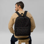 Daemon Luxury Speckled Diamonds NEMESIS backpack with white all-over print, showing front view with adjustable straps.