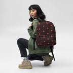 Daemon Luxury Supreme Models WEBBI DAIMIN all-over-print backpack in white, featuring bold graphic design on the front.