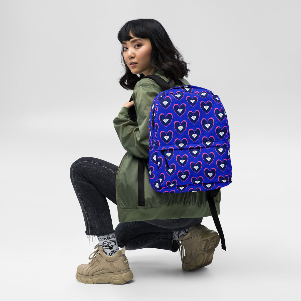 White all-over-print backpack by Daemon Luxury featuring a unique ELECTRICA (Foreigners Gem) design on the front.