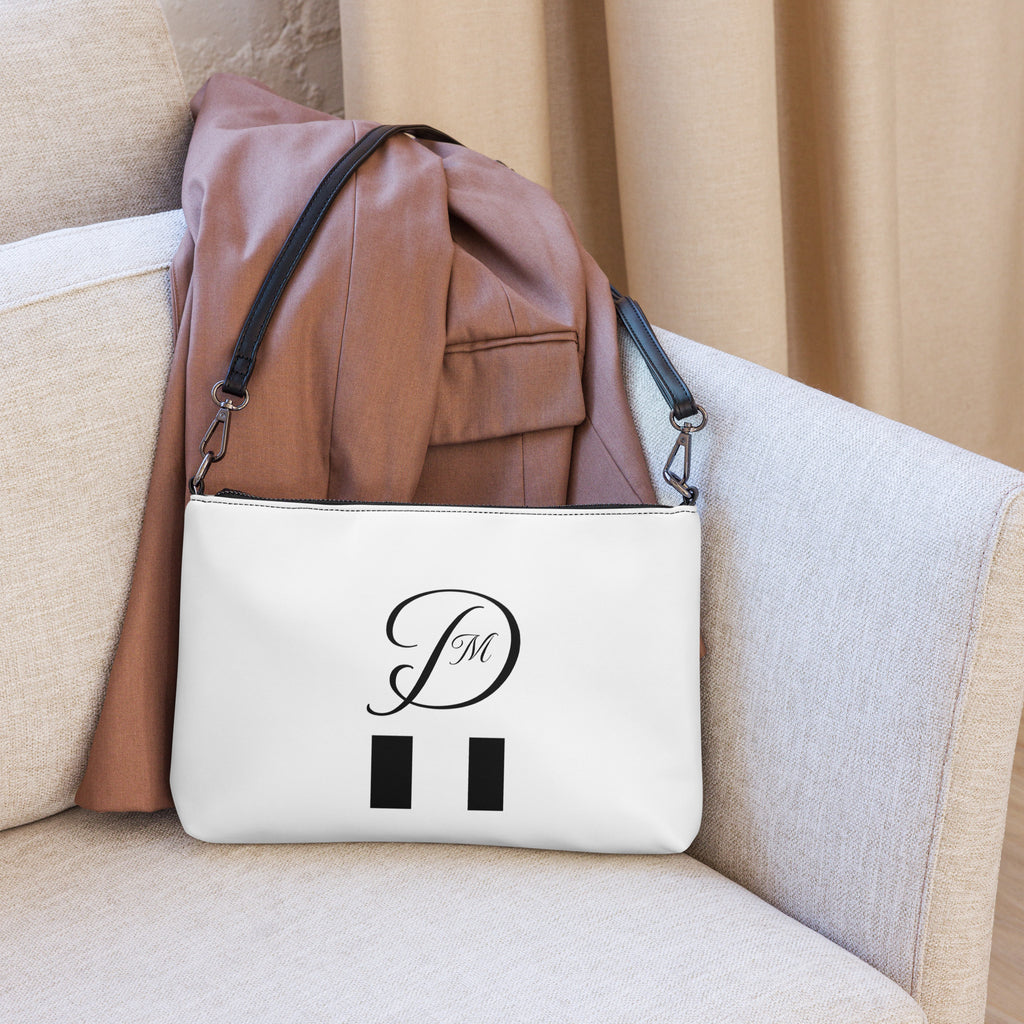Daemon Luxury Metronome Paris More Love crossbody bag with all-over black print, stylish and compact accessory.