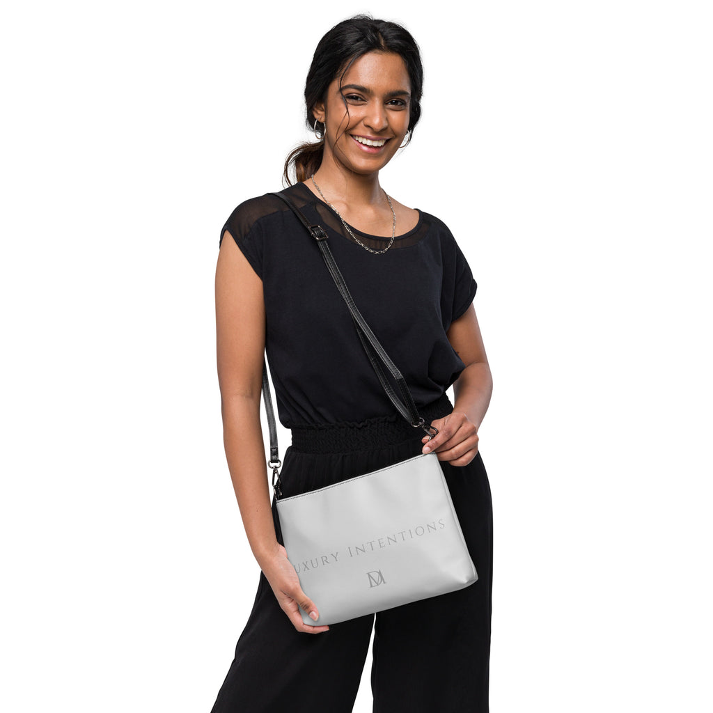 Black NARDO Scale sunless dream crossbody bag by Daemon Luxury with all-over print and adjustable strap.