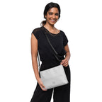 Black NARDO Scale sunless dream crossbody bag by Daemon Luxury with all-over print and adjustable strap.