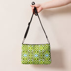 Daemon Luxury Belly Red’s Garden Borsetta crossbody bag with all-over black print and adjustable strap, stylish and compact.