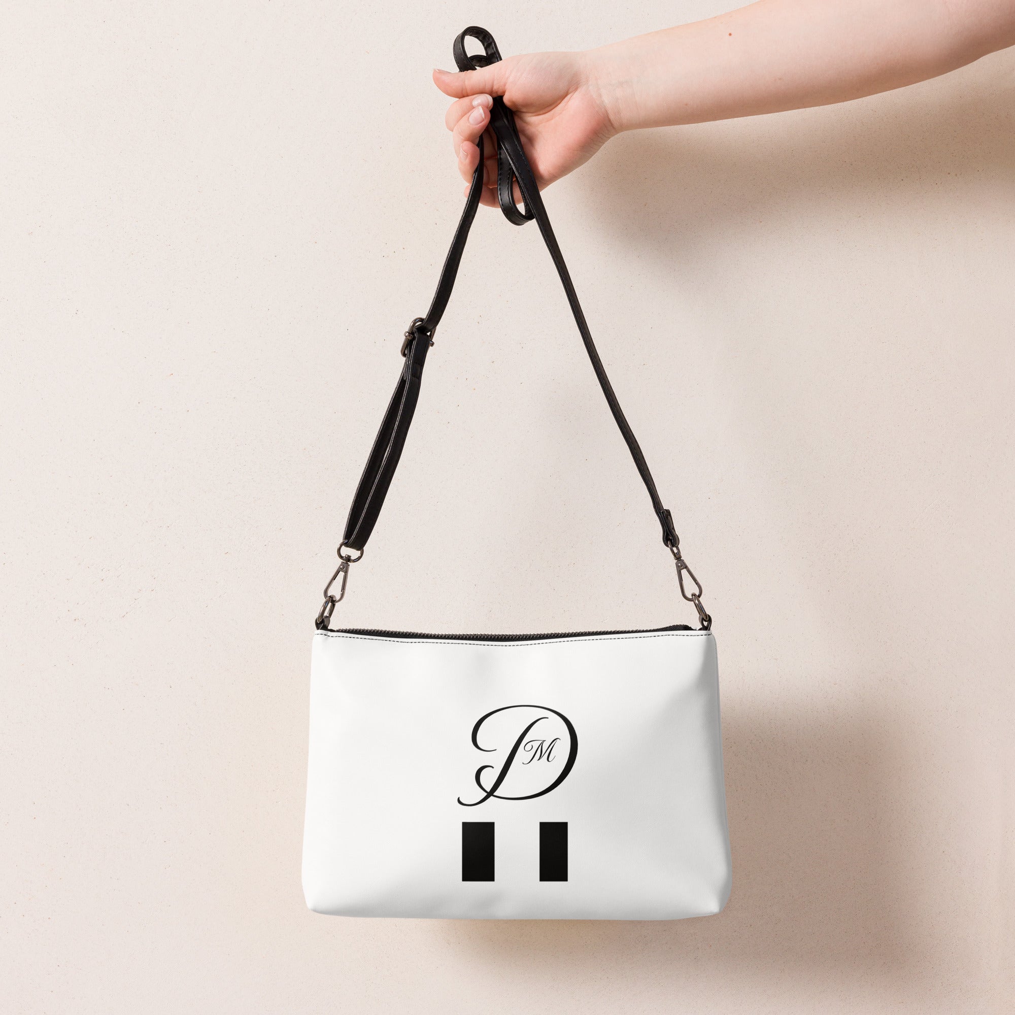 Daemon Luxury Metronome Paris more love crossbody bag with all-over black print, front view showing stylish design and branding.