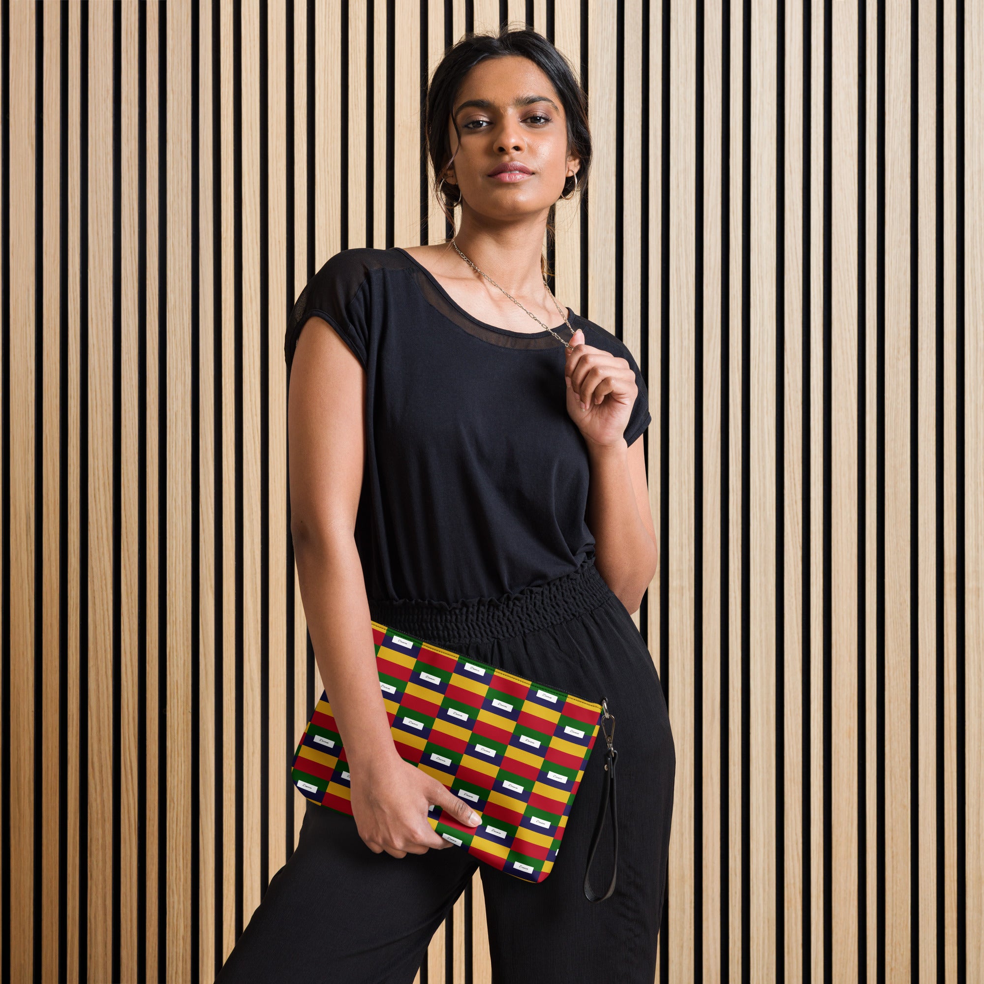 Black crossbody bag with all-over ruby stones print by Daemon Luxury, featuring a compact design and adjustable strap.