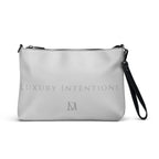 Black NARDO Scale all-over-print crossbody bag by Daemon Luxury with adjustable strap and stylish design.