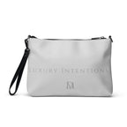 White NARDO Scale sunless dream crossbody bag by Daemon Luxury with all-over print and adjustable strap.