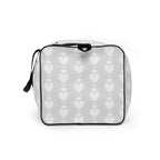 White all-over-print duffle bag with frosted heartfelt sunless design by Daemon Luxury, showing the left side.