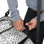 White Daemon Luxury Dim Diamonds Artica Nero duffle bag with all-over Diamond pattern and sturdy handles.