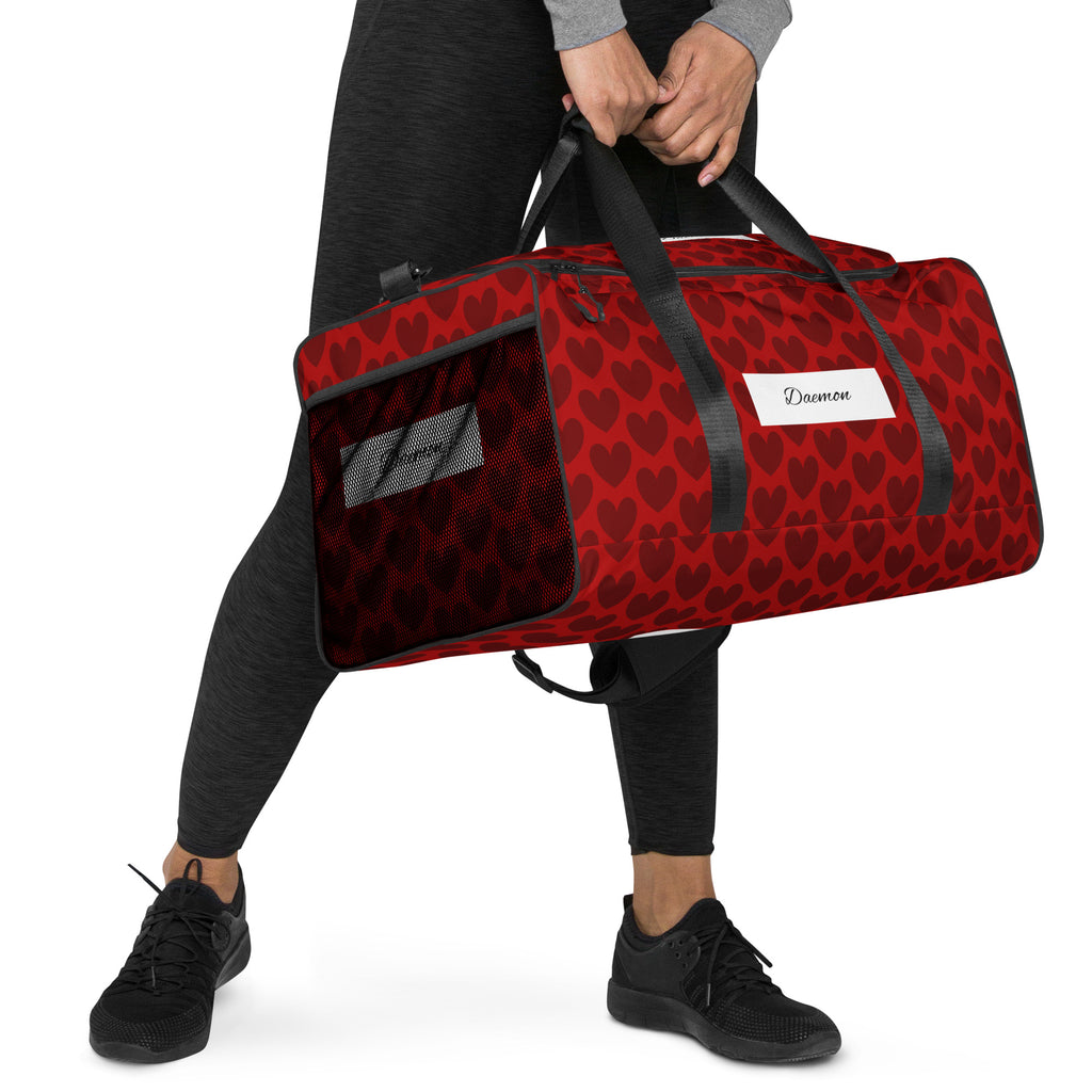 Daemon Luxury Heartfelt white duffle bag with all-over print, featuring sturdy handles and spacious interior for travel and gym use.
