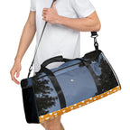 Daemon Luxury Crescent City Borsone duffle bag with all-over white print, showing right-front view with handles and zipper detail.