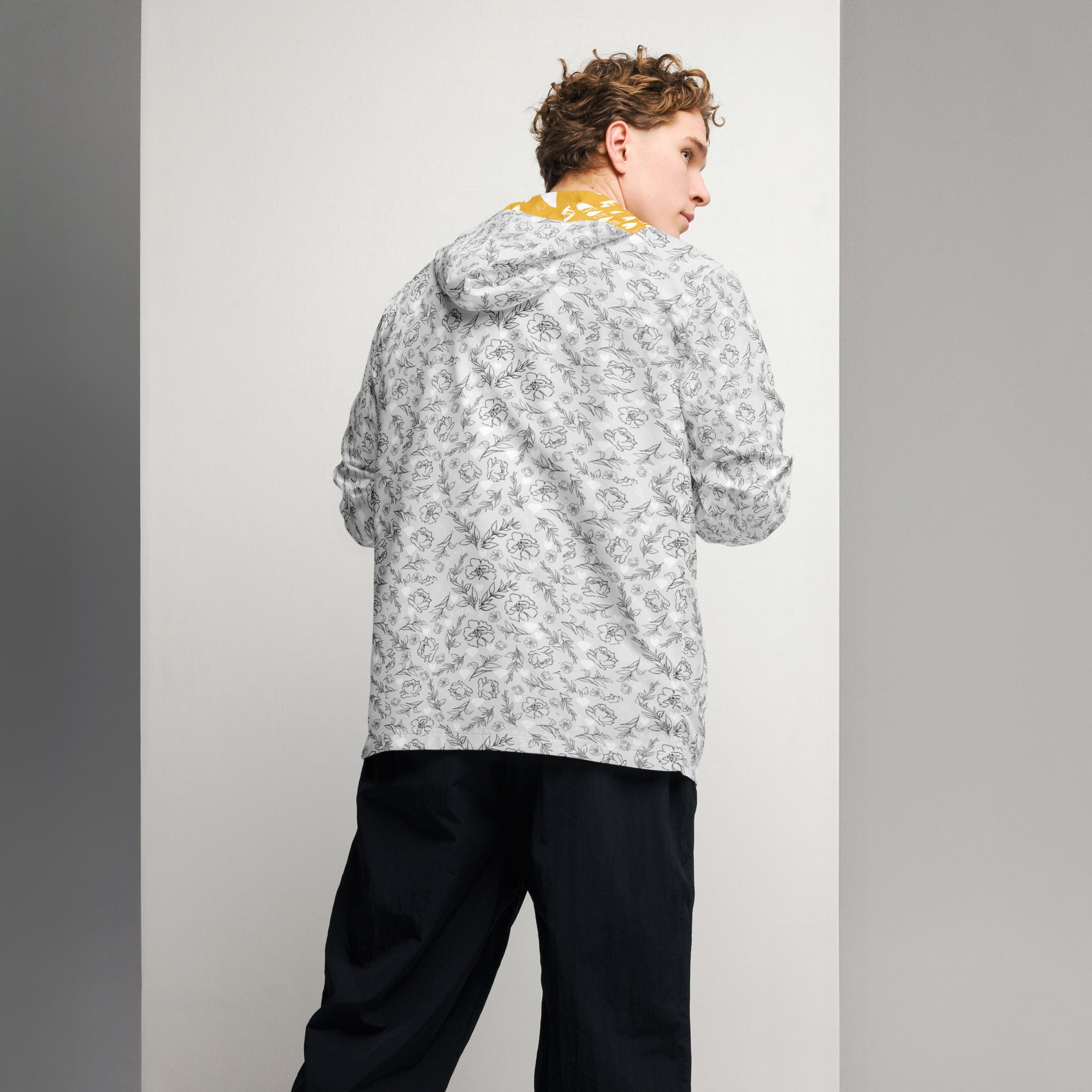 White men's windbreaker jacket with all-over Florette Rebirth luxury era print by Daemon Luxury, back view.