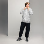 White men's windbreaker jacket with all-over luxury era Florette Rebirth print by Daemon Luxury, front view.