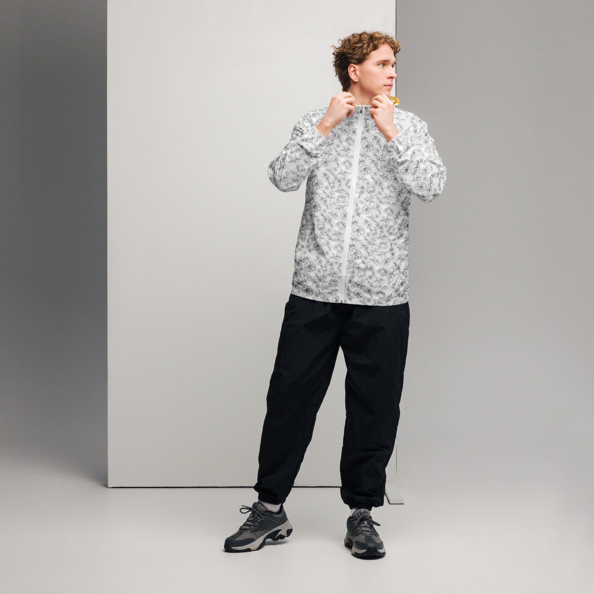 White men's windbreaker jacket with all-over luxury era Florette Rebirth print by Daemon Luxury, front view.