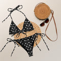 Daemon Luxury Frosted Diamonds Dolce Scusa recycled string bikini with all-over white print, front view showing intricate pattern.