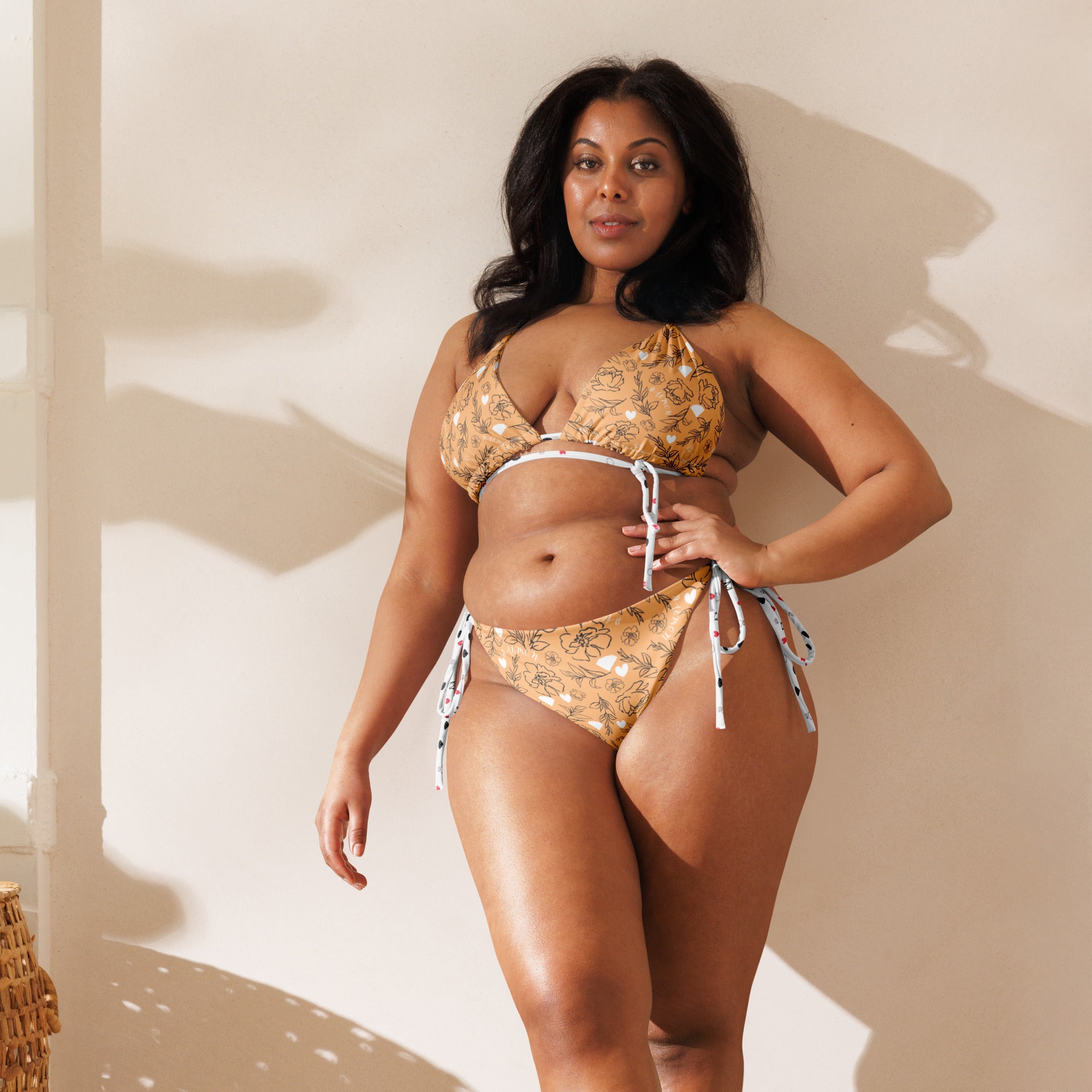 Daemon Luxury Florette Rebirth Sienna Dulce Scusa recycled string bikini with all-over white print, front view.