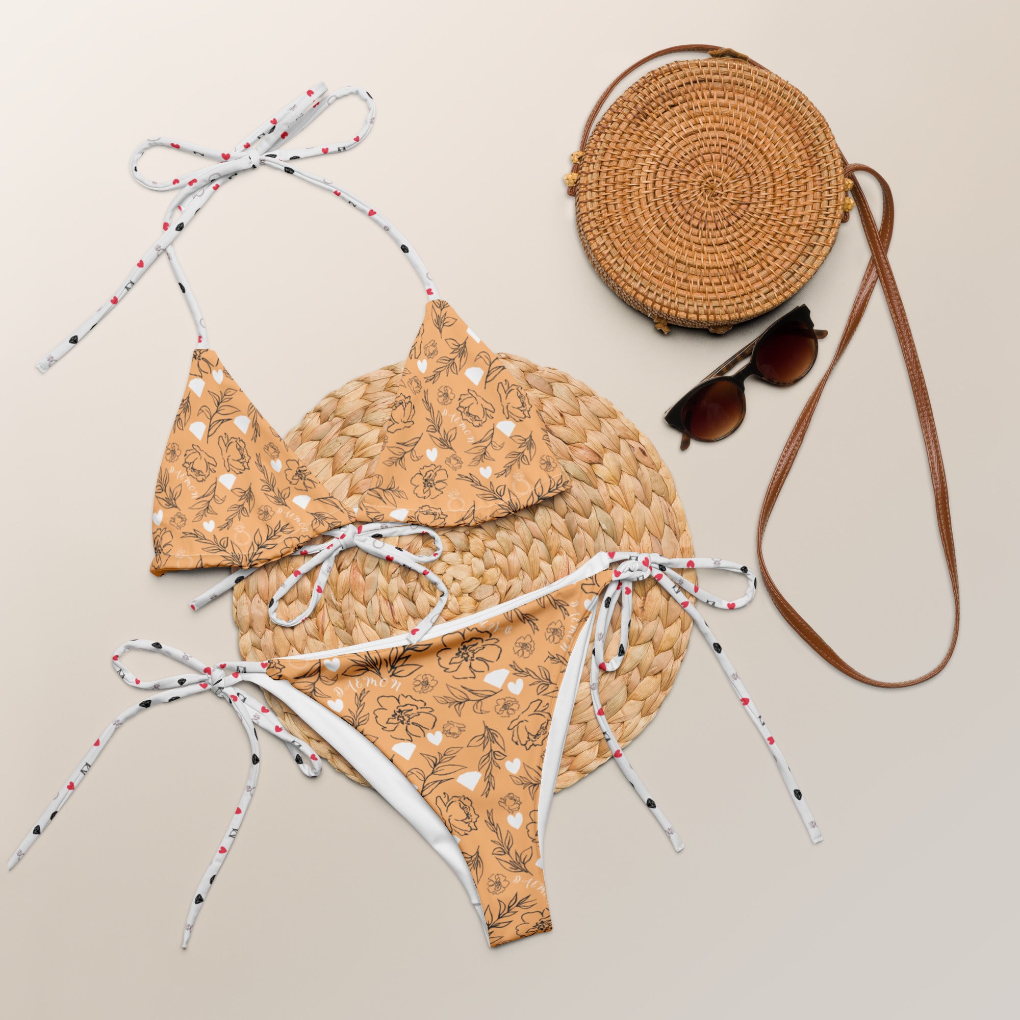 Daemon Luxury Florette Rebirth Sienna Dulce Scusa recycled string bikini with all-over white print, front view showing vibrant design.