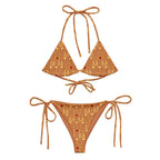 Daemon Luxury Tarmin Dim Sun Glow Dulce Scusa recycled string bikini in white with all-over print, front view.