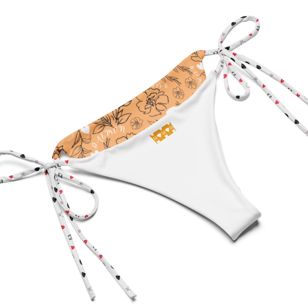 Daemon Luxury Florette Rebirth Sienna Dulce Scusa recycled string bikini with all-over white print, showcasing its vibrant design.