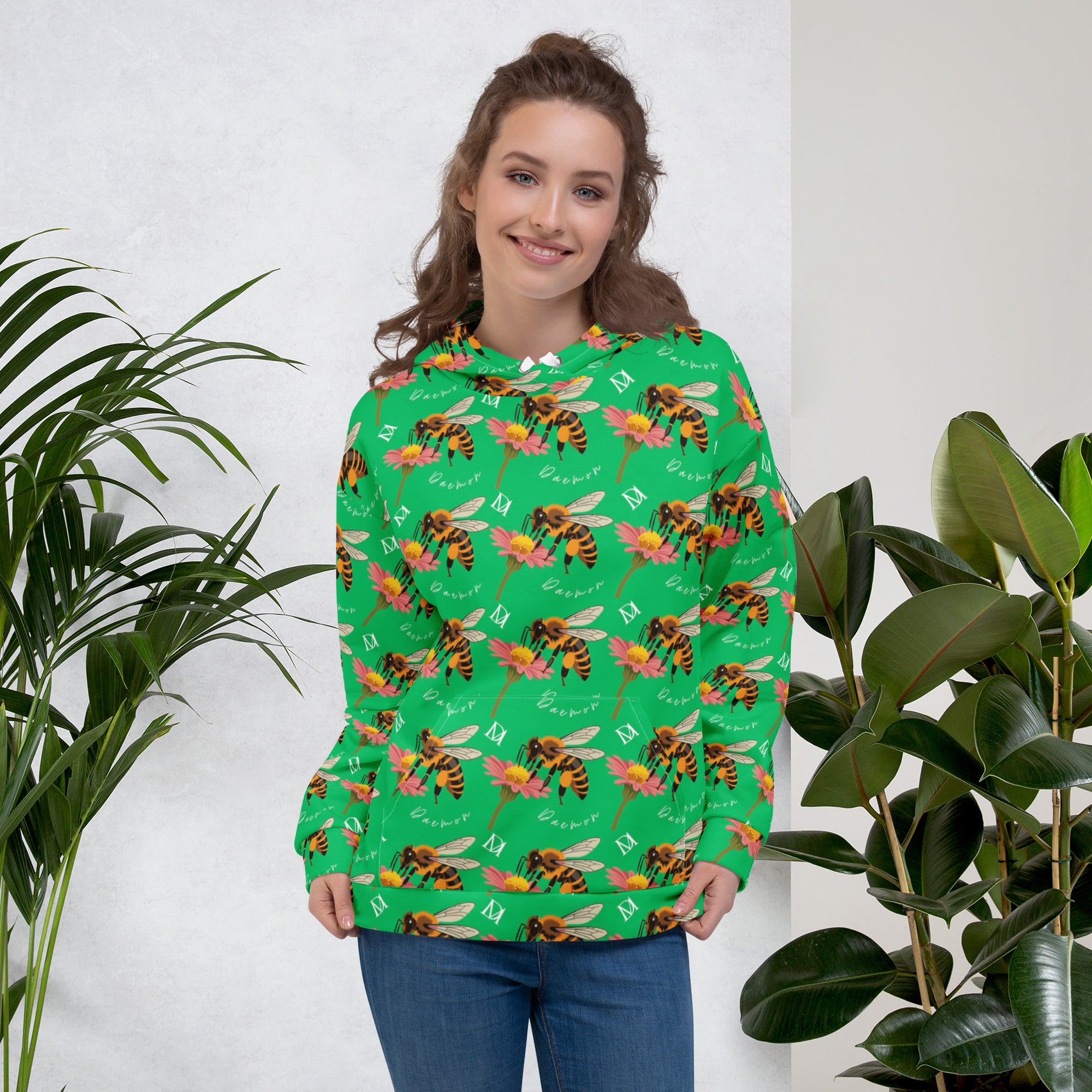 White recycled unisex hoodie with Honeybee Shores Lucky Charm print by Daemon Luxury, featuring all-over colorful design and front pocket.