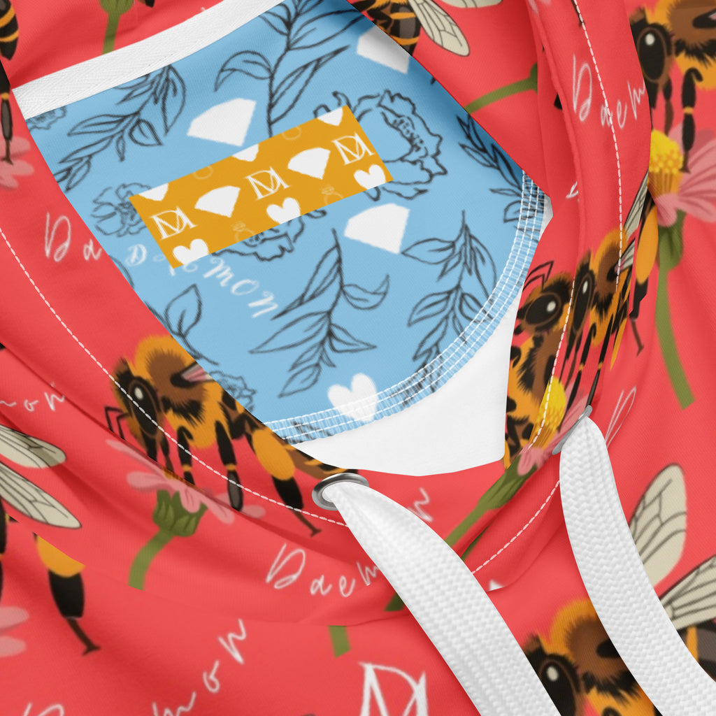 Unisex white recycled hoodie with all-over honeybee shores and Tarmin’s Heart print by Daemon Luxury, featuring a hood and casual fit.