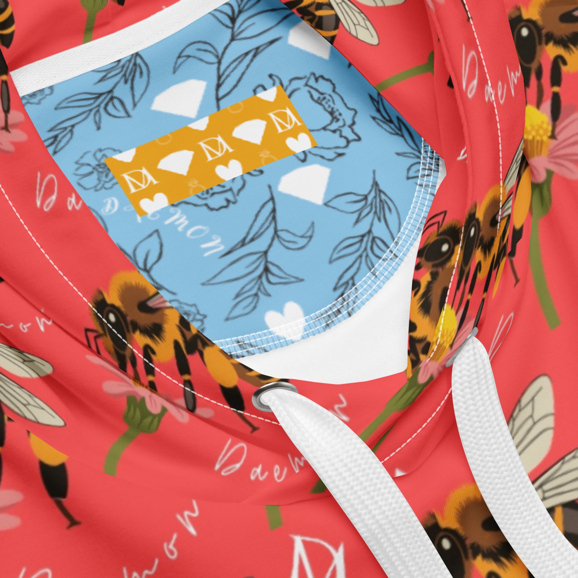 Unisex white recycled hoodie with all-over honeybee shores and Tarmin’s Heart print by Daemon Luxury, featuring a hood and casual fit.