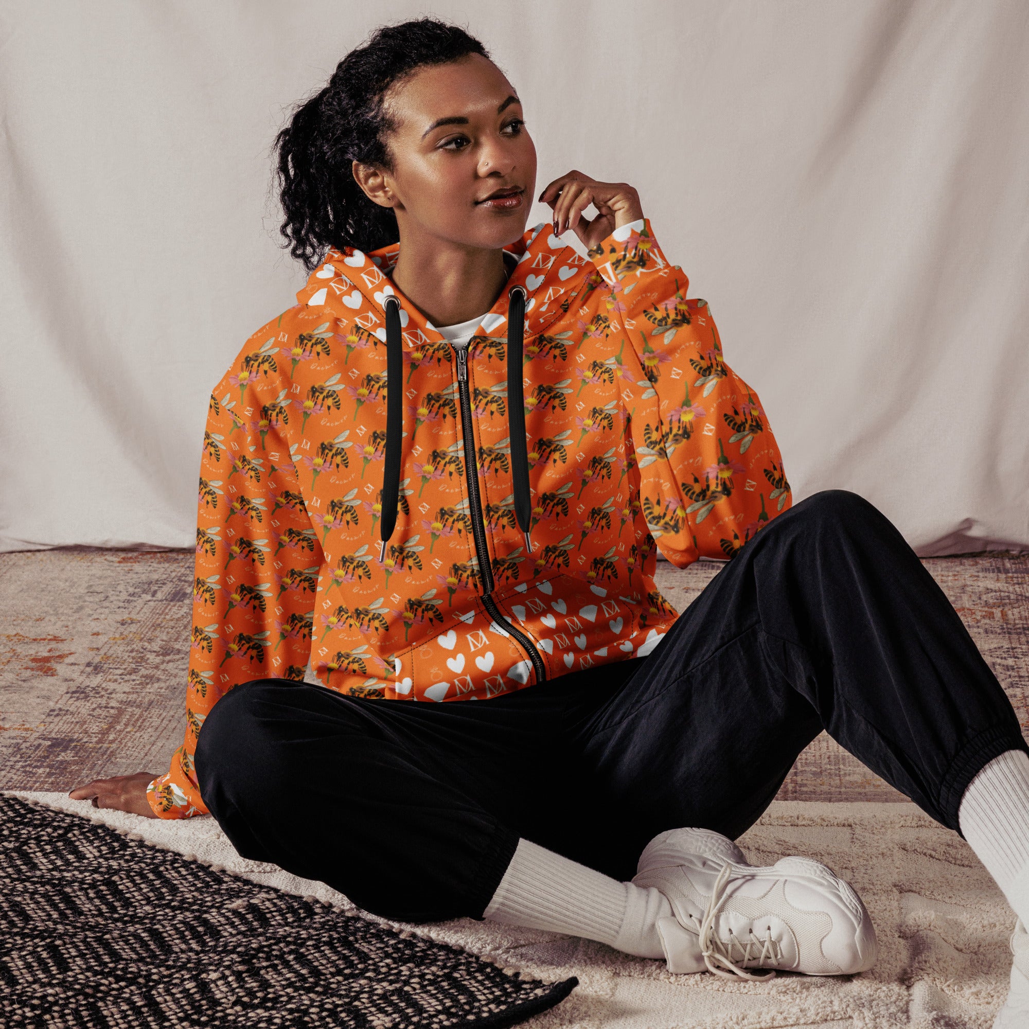Daemon Luxury Quintara’s Sunset California Honeybee unisex zip hoodie with all-over recycled print on white fabric.