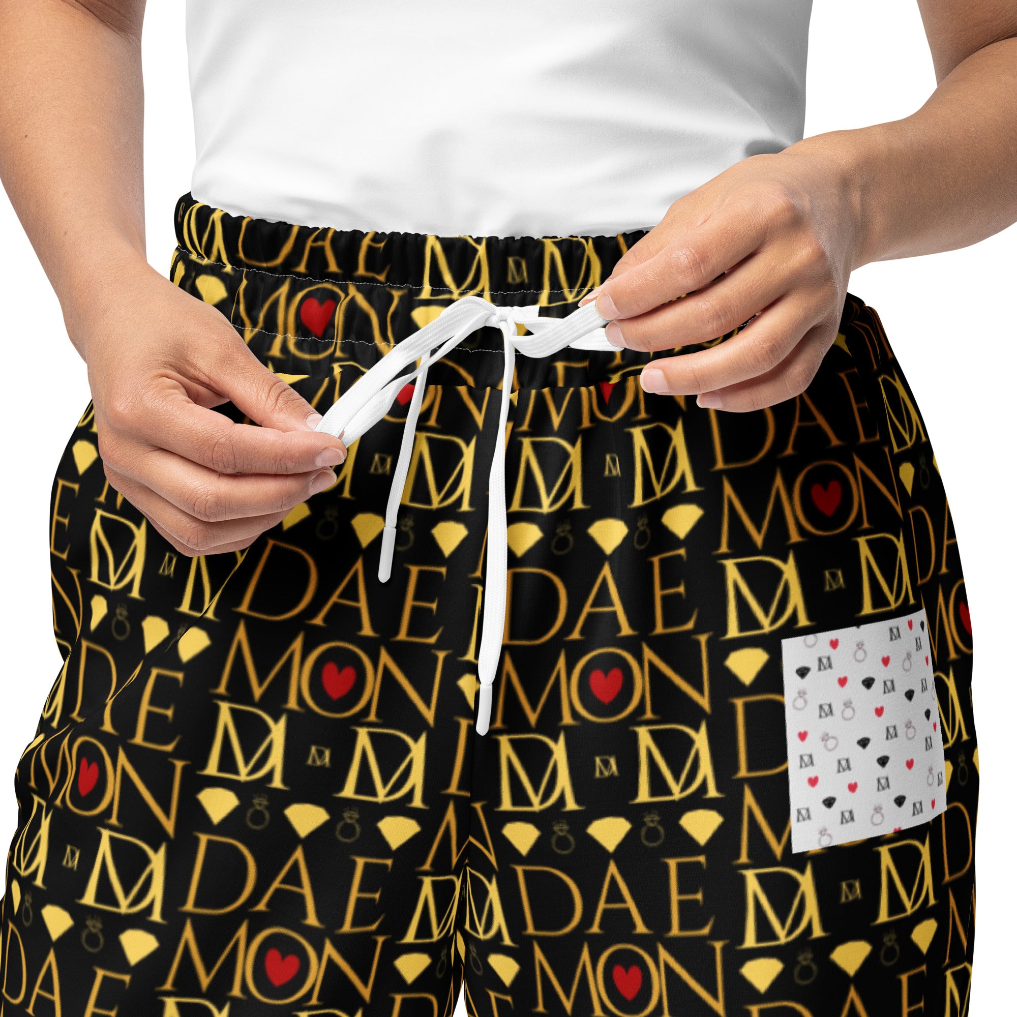 All-over print white unisex wide-leg joggers with Sun Glow California design by Daemon Luxury, front view.