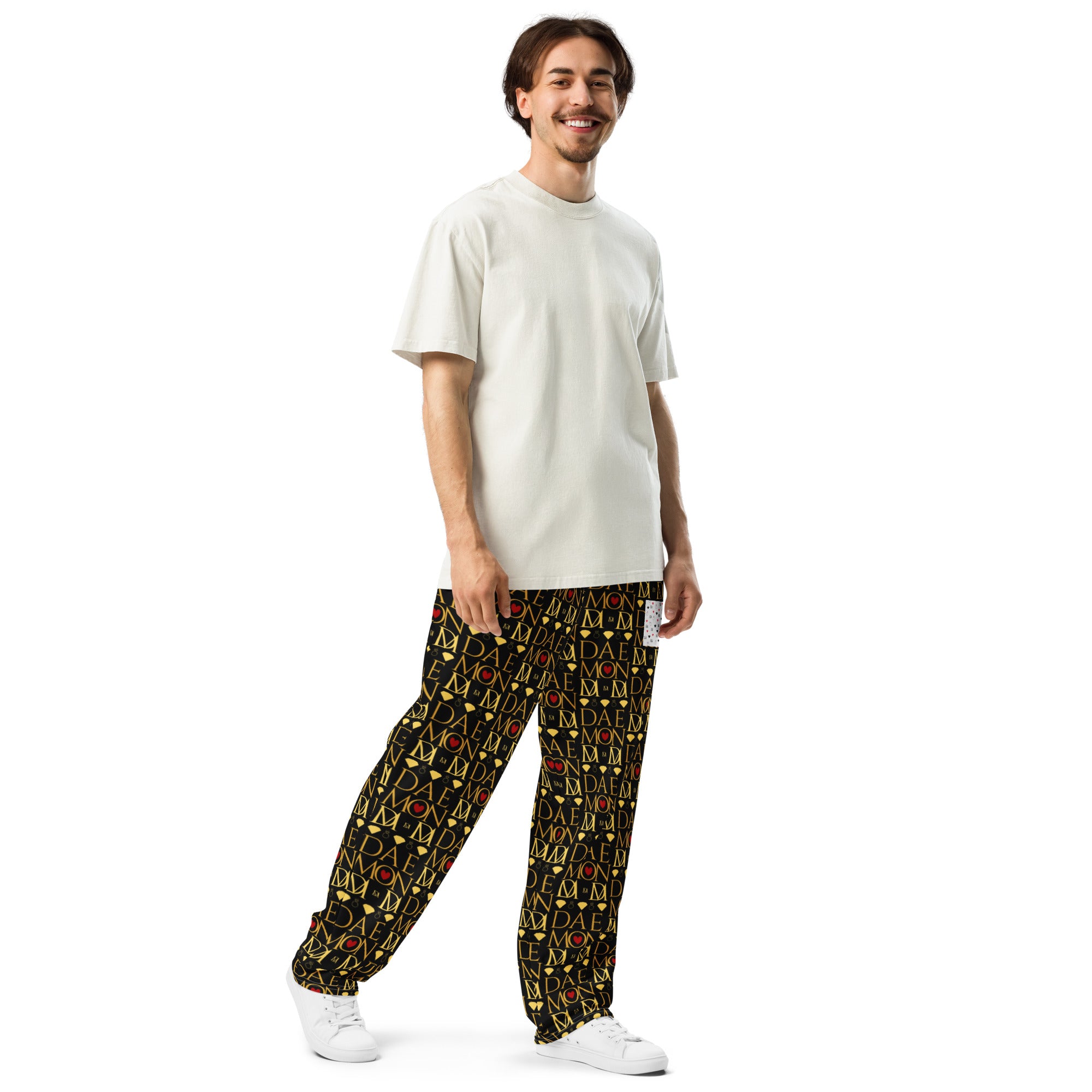 Daemon Luxury Sun Glow California all-over-print unisex wide-leg joggers in white, shown from the right front angle.