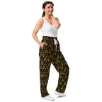 Unisex wide-leg joggers with sun glow California all-over print by Daemon Luxury, shown from the right front.