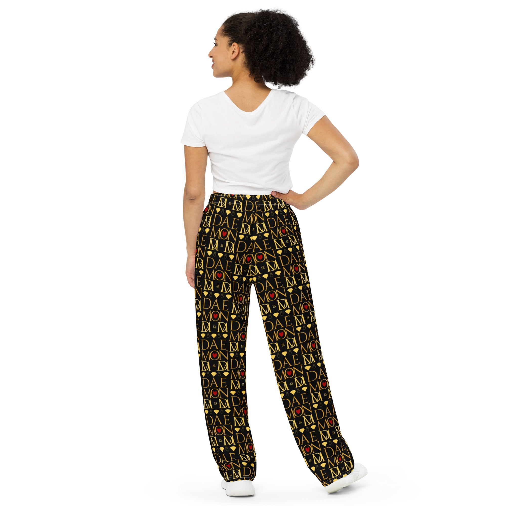 Unisex wide-leg lounge pants with Sun Glow California all-over print by Daemon Luxury, shown from the back in white.