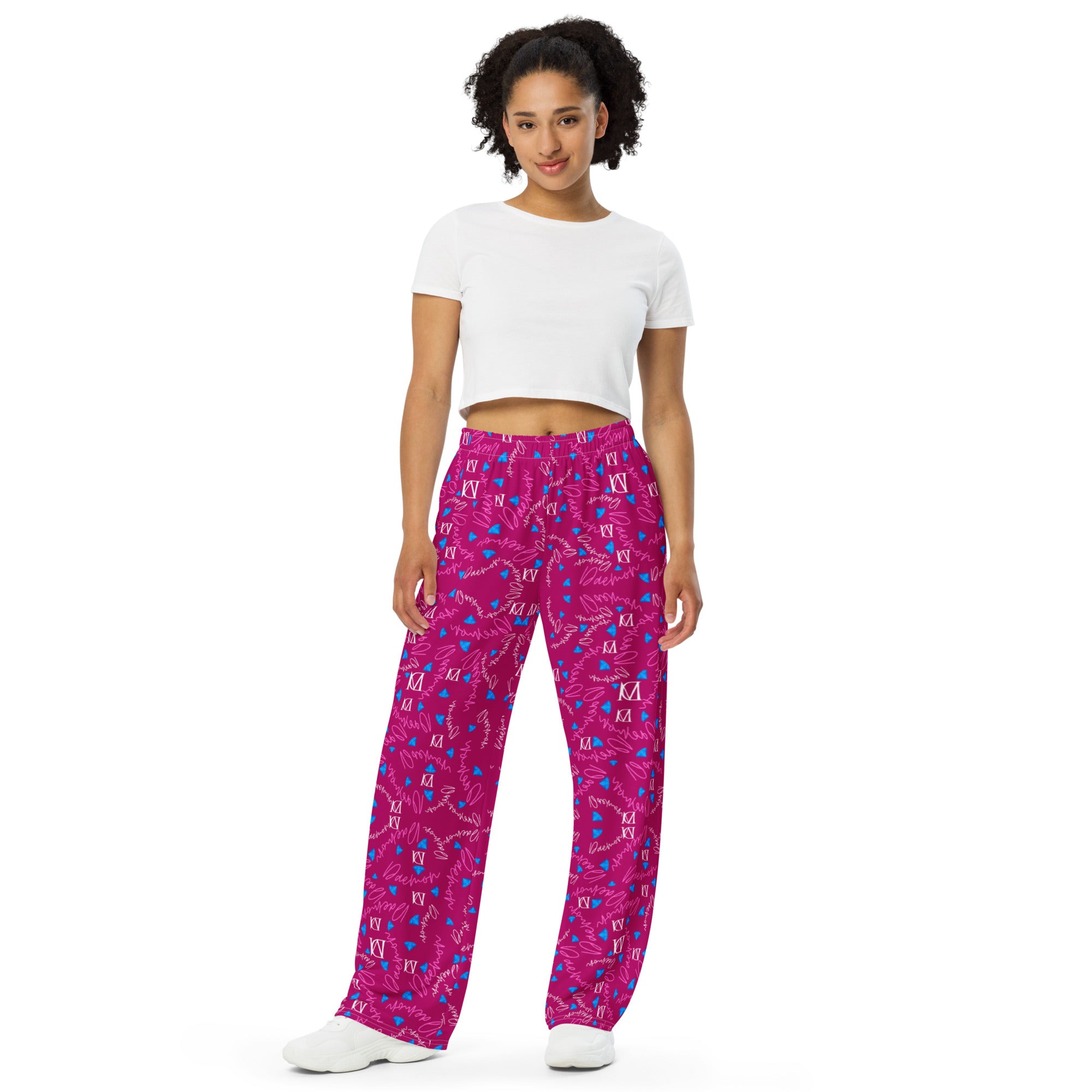 Unisex wide-leg pants with all-over magenta Picasso mirror print by Daemon Luxury, front view showing bold artistic design.