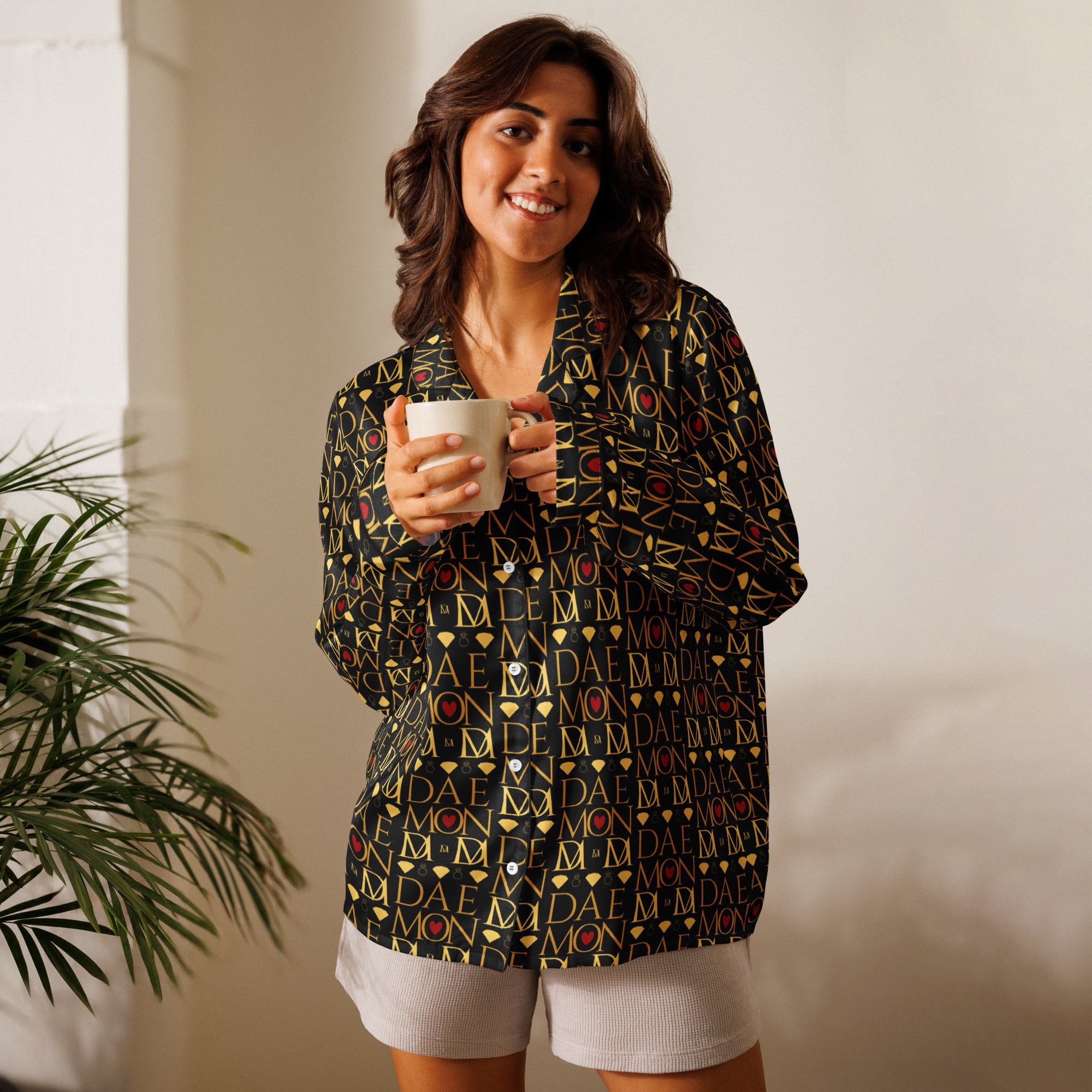 Daemon Luxury Sun Glow California women's long-sleeve silk pajama top with black all-over print and front design.