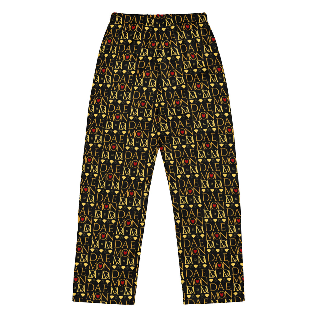 Daemon Luxury Sun Glow California women's silk pajama pants with all-over black and colorful print, back view.