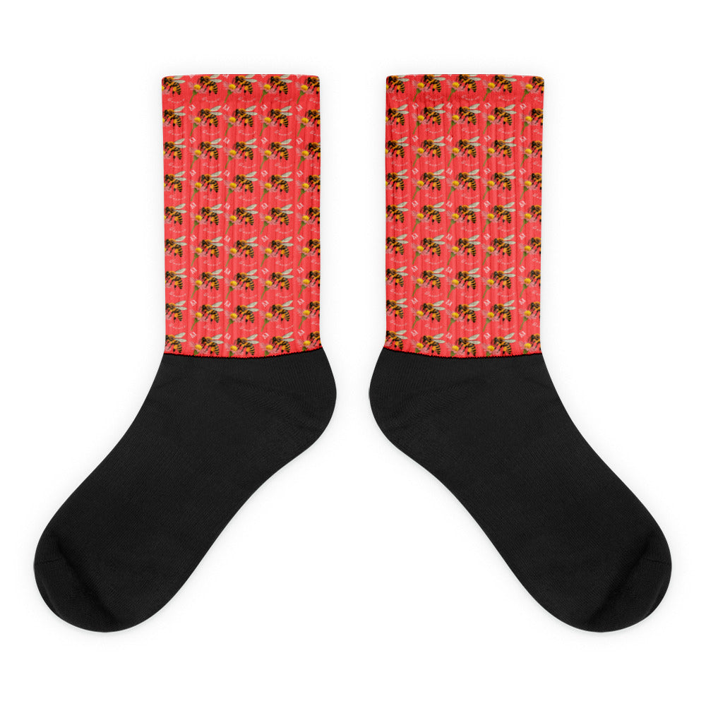 Daemon Luxury Honeybee Shores (Tarmin’s Heart) black sublimated socks with intricate bee and floral designs, flat view.