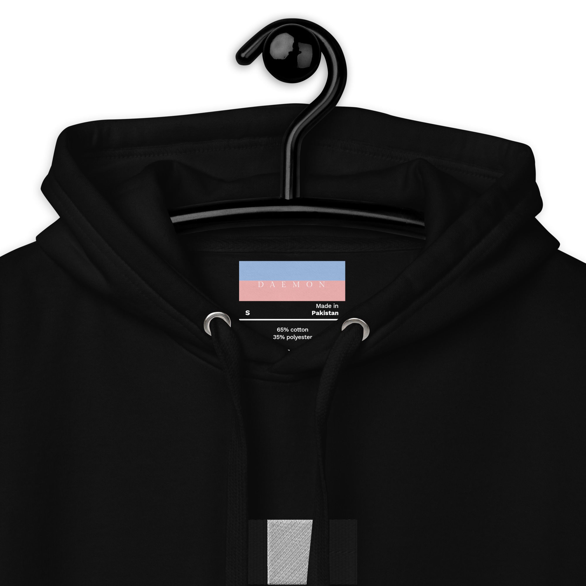Daemon Stealth Pardon unisex black hoodie with cotton heritage fabric and drawstring hood, close-up view showing fabric texture.