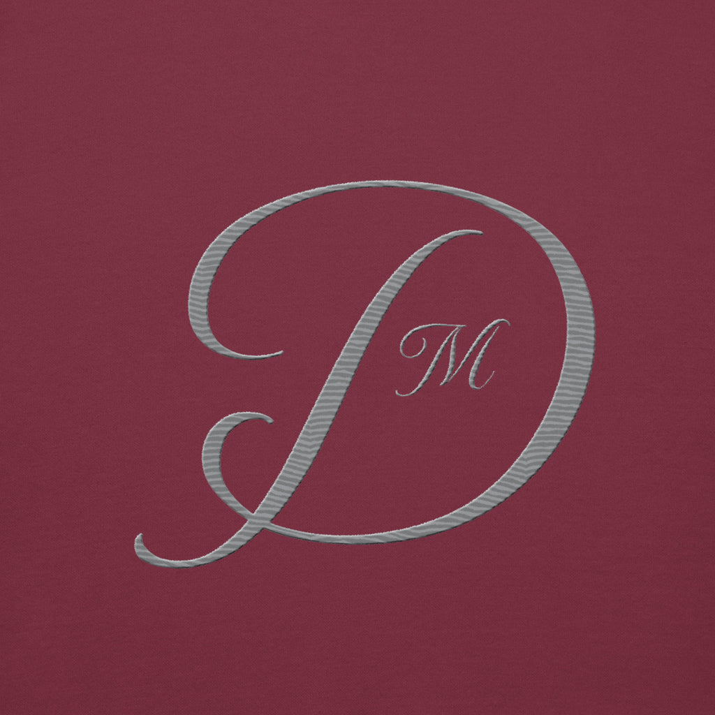 Maroon unisex luxury hoodie by Daemon, crafted from premium cotton, featuring a hood and casual fit.