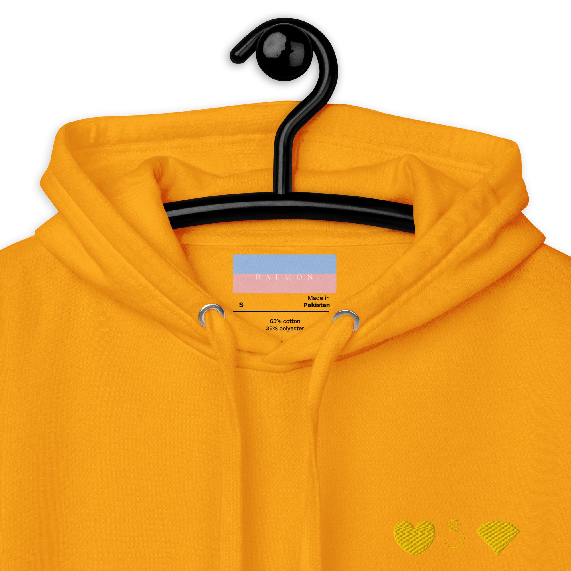 Close-up of Daemon Gold Tender Bandit unisex hoodie with cotton heritage fabric and hood, showing detailed stitching.