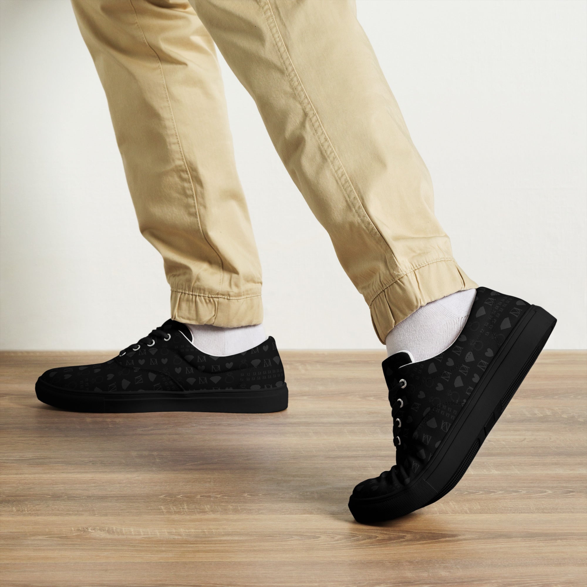 Black men's lace-up canvas shoes from Daemon Luxury with frosted diamond platinum details and stylish front view.
