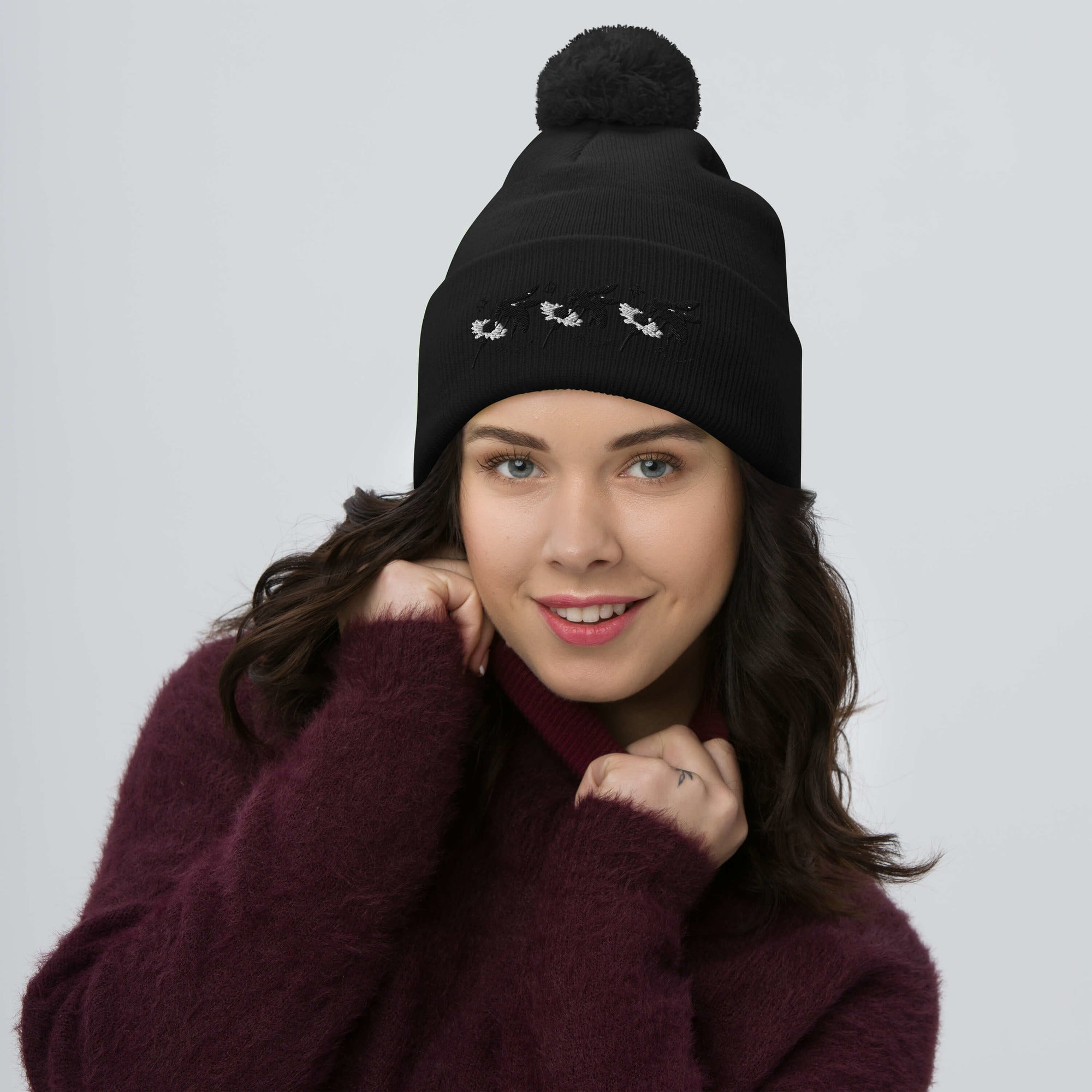 Black pom-pom knit cap from Daemon Luxury Night Captain (Single Vision) collection, featuring a cozy wool design and front view.