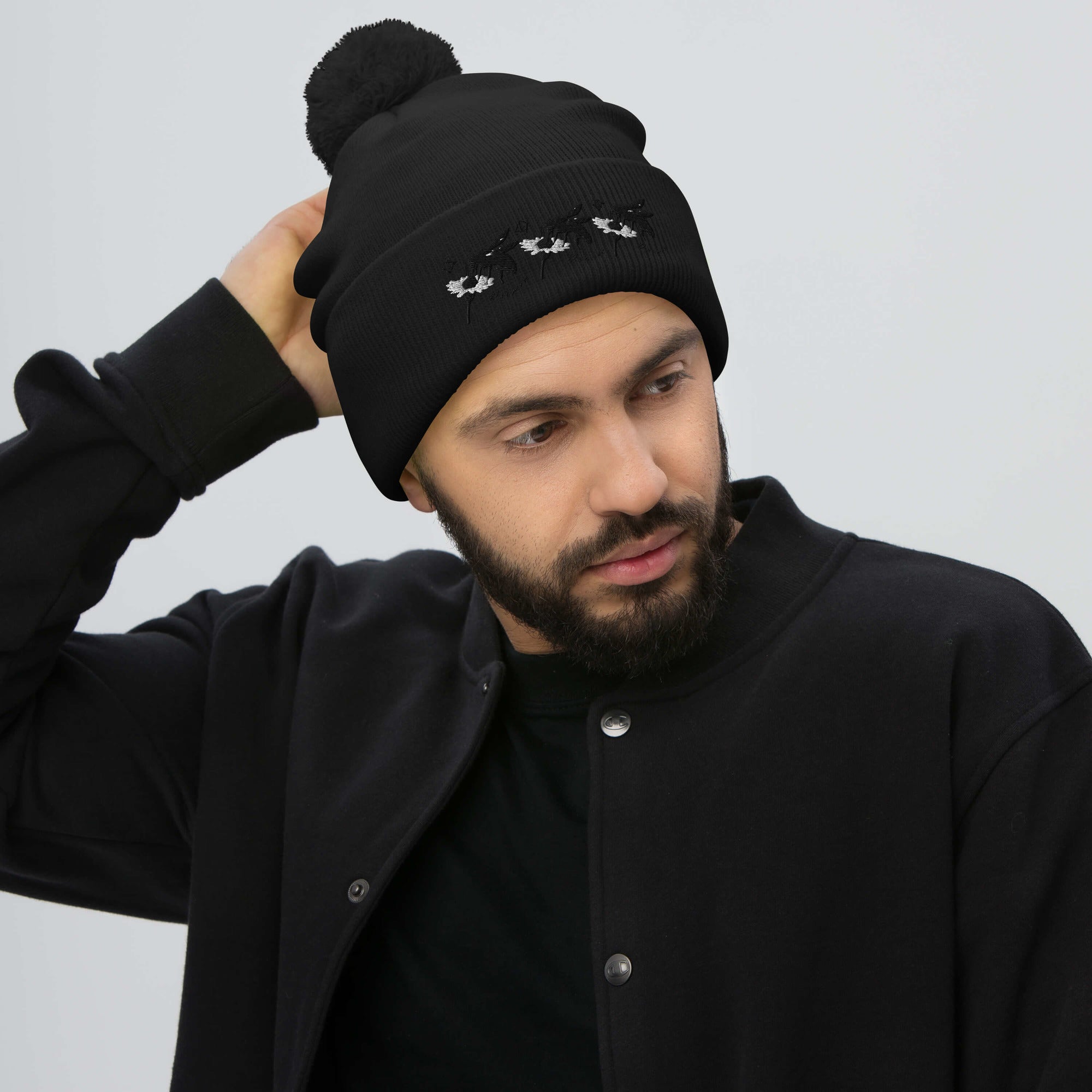 Black pom-pom knit beret from Daemon Luxury Night Captain single vision collection, stylish and cozy winter accessory.