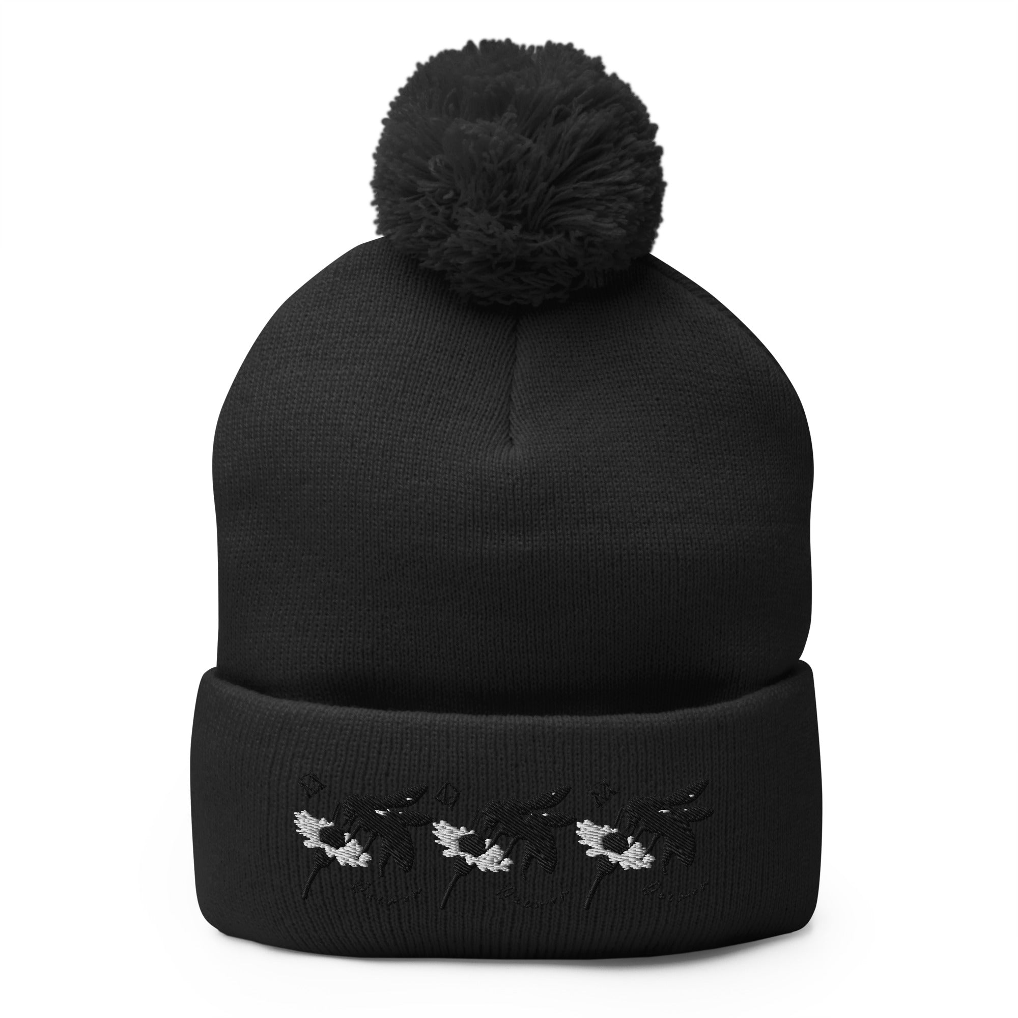 Black pom-pom knit cap from Daemon Luxury's Night Captain collection, featuring a stylish front view and cozy wool material.