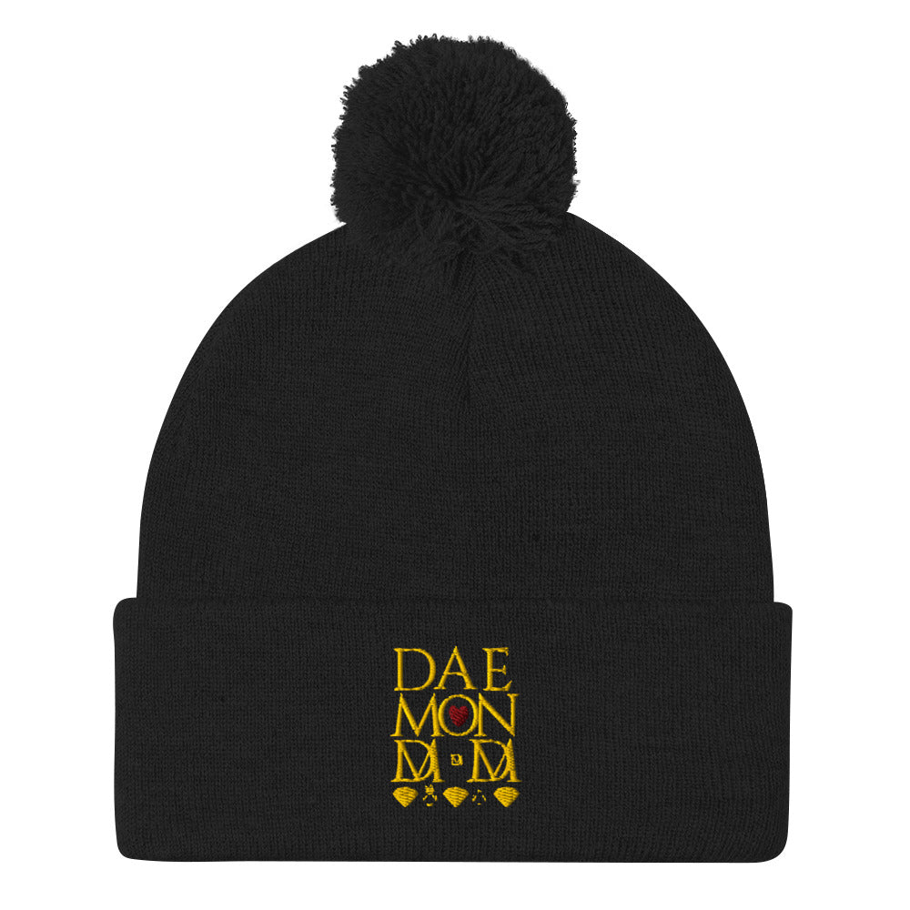 Black Nemesis Sun Glow wool knit cap with pom-pom detail by Daemon Luxury, front view of the cozy winter beanie.