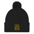 Black Nemesis Sun Glow wool knit cap with pom-pom detail by Daemon Luxury, front view of the cozy winter beanie.