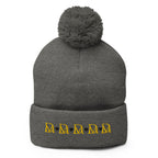 Daemon Luxury Stormless Dim Sun Glow pom-pom-knit wool cap in dark heather grey, front view showcasing cozy winter style.