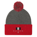 Daemon Luxury Lux Class Snow Light pom-pom-knit wool cap in dark heather grey with red accents, featuring a cozy knit design.