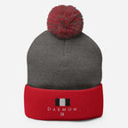 Daemon Luxury Lux Class Snow Light pom-pom knit cap in dark heather grey and red, cozy wool hat with a pom-pom detail.