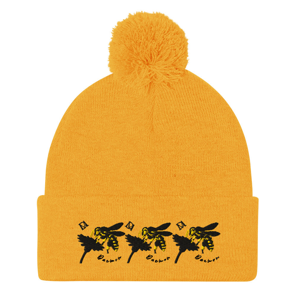 Daemon Luxury Honeybee California pom-pom knit cap in gold, showcasing a stylish front view with cozy, textured knit fabric.