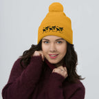 Golden pom-pom knit cap by Daemon Luxury from Honeybee California G.T. Caped Heroes collection, featuring a front view.