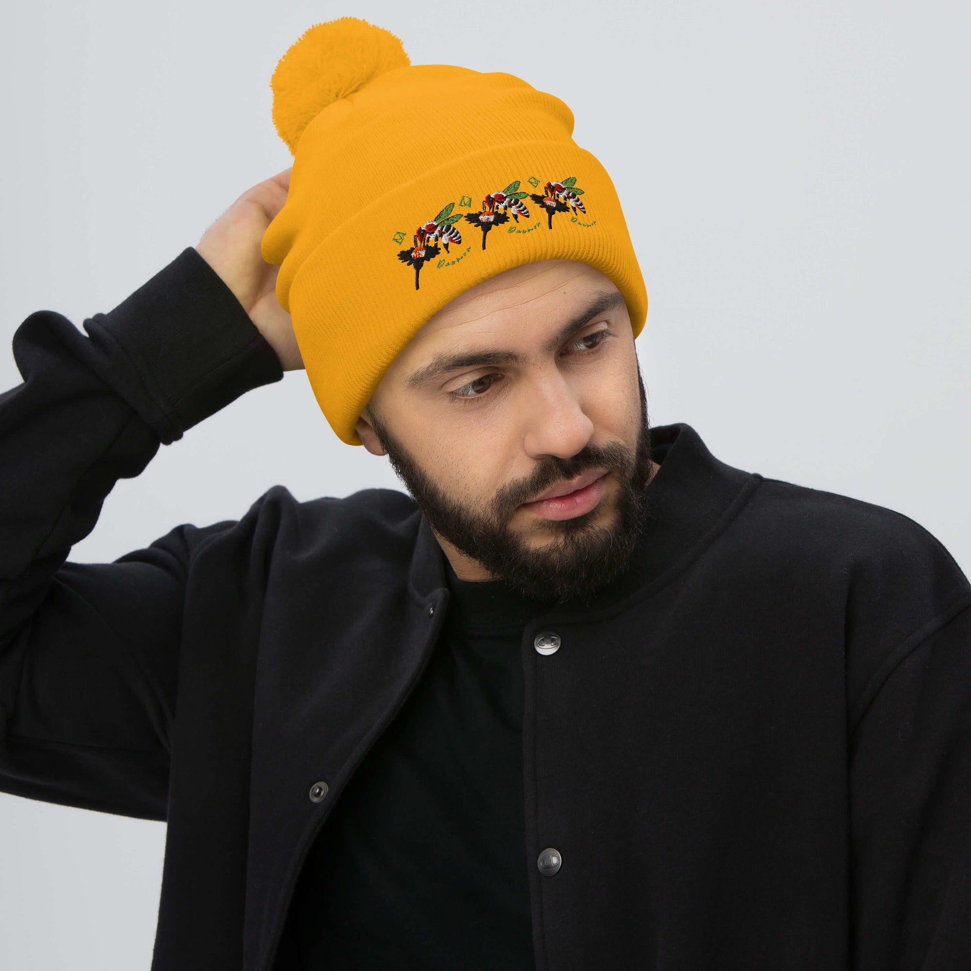 Daemon Luxury Honeybee California Gold Tender pom-pom knit lana cap, front view with cozy texture and stylish design.